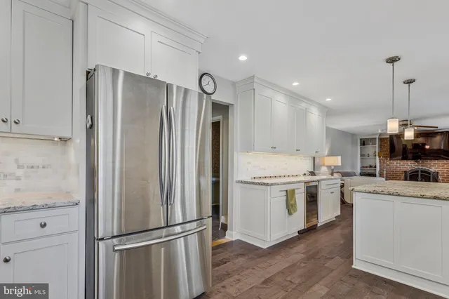 a kitchen with a refrigerator sink and stainless steel appliances