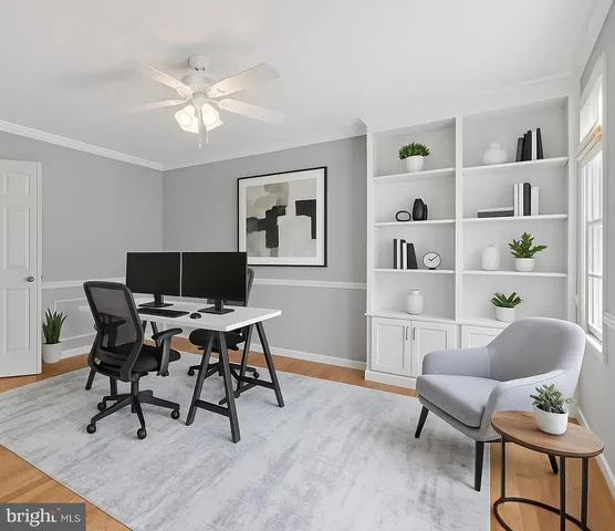 a workspace with furniture wooden floor and a window