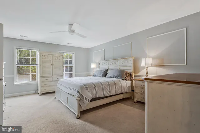a spacious bedroom with a bed and a cabinets