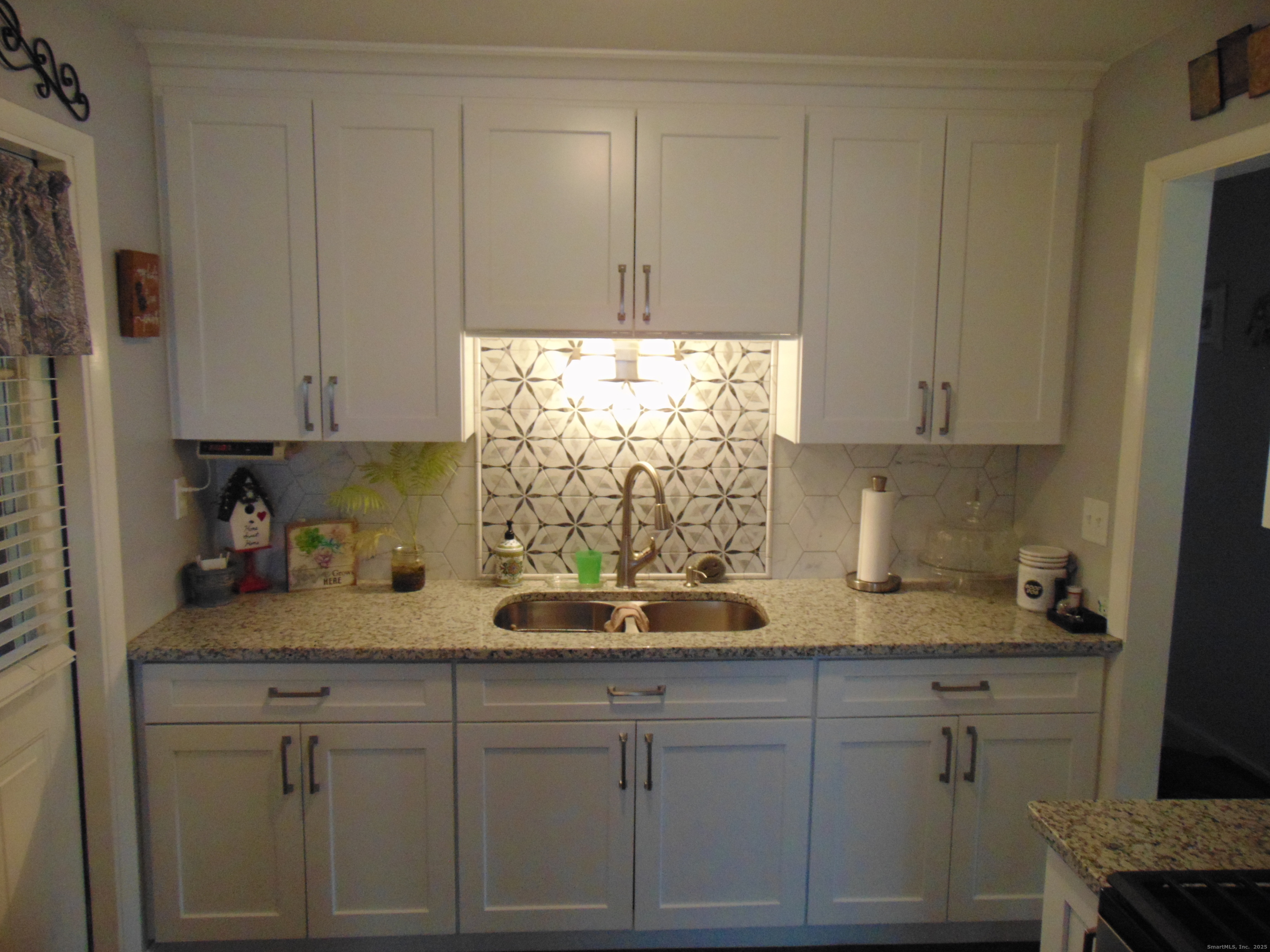 57 Alling Street Extension West Haven, CT 06516 - Photo 17 of 38 a kitchen with granite countertop white cabinets and white appliances