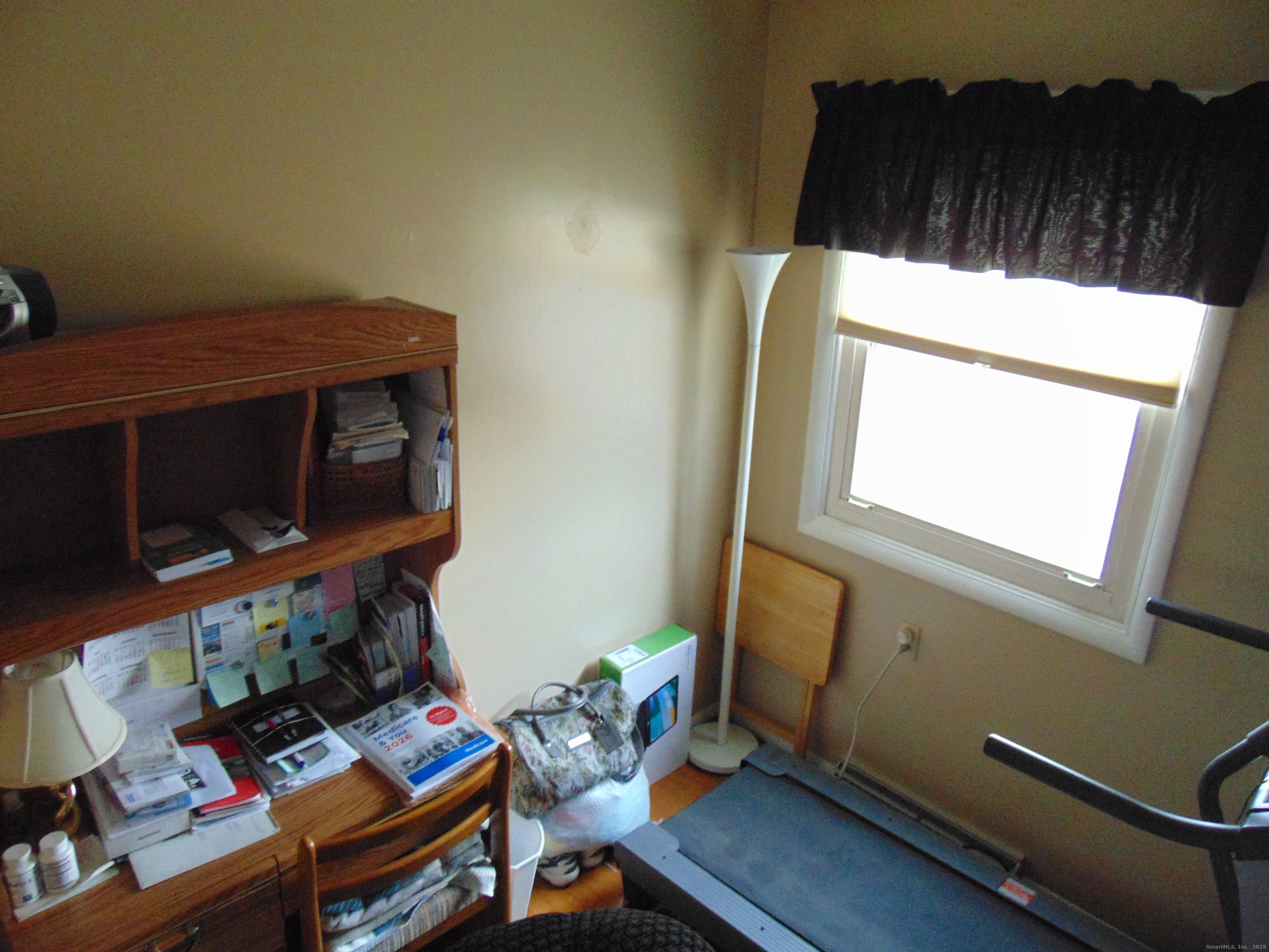 57 Alling Street Extension West Haven, CT 06516 - Photo 29 of 38 a living room with a bed furniture and a window