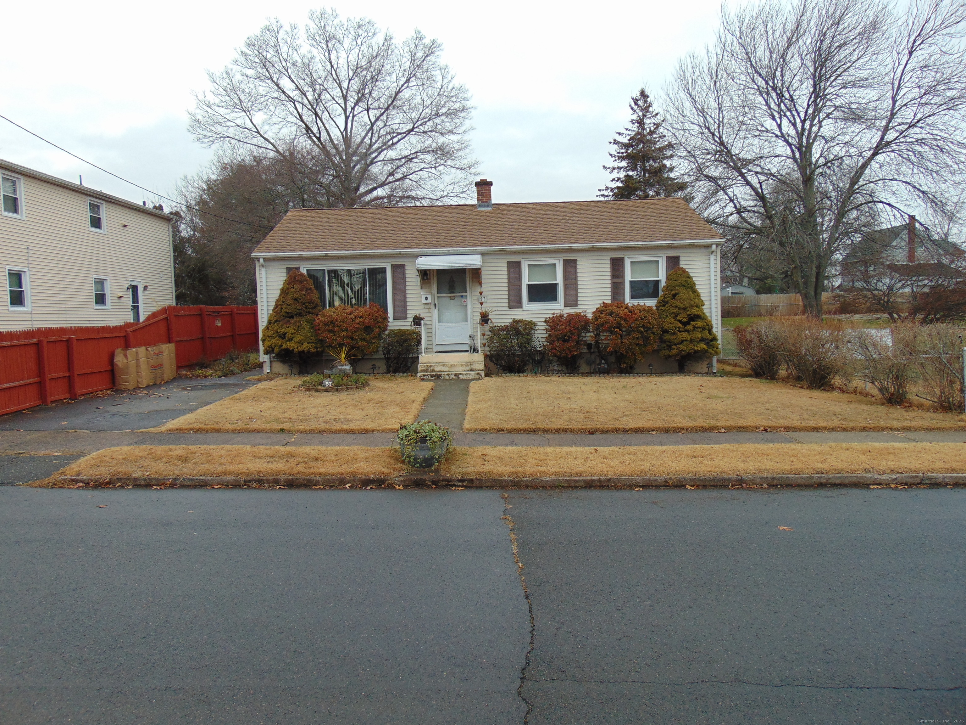 57 Alling Street Extension West Haven, CT 06516 - Photo 3 of 38 a front view of a house with a yard and a garage