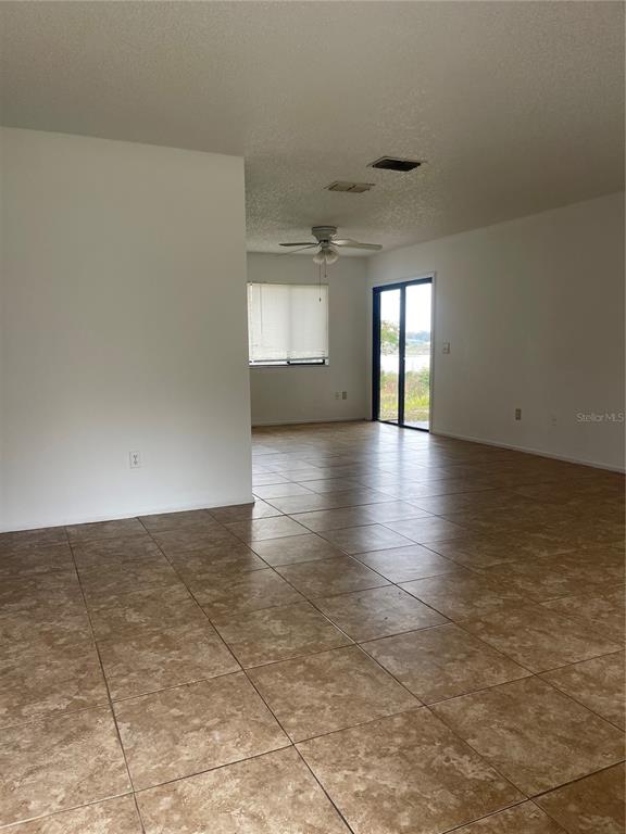 1015 Hickory Road Ocala, FL 34472 - Photo 3 of 14 an empty room with wooden floor and windows