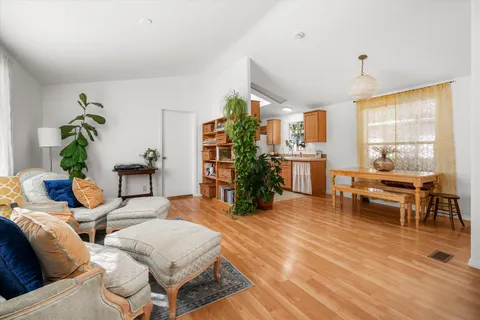 a living room with fireplace furniture and a large window