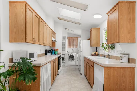 a kitchen with a sink stove and cabinets