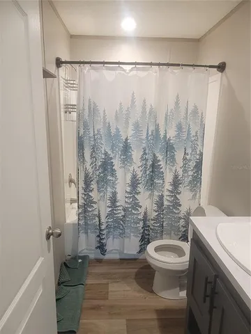 a bathroom with a shower a toilet and sink