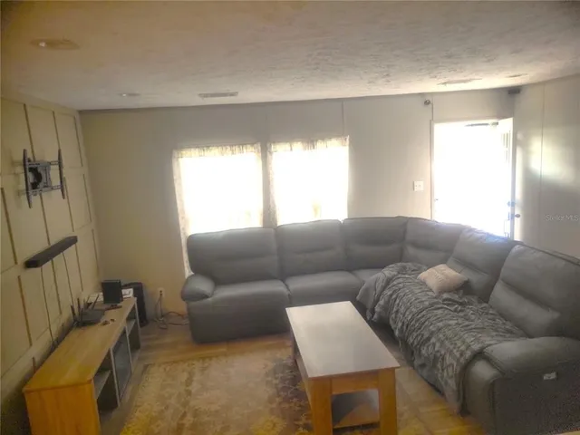 a living room with furniture and a window