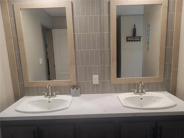 a bathroom with a sink and a mirror