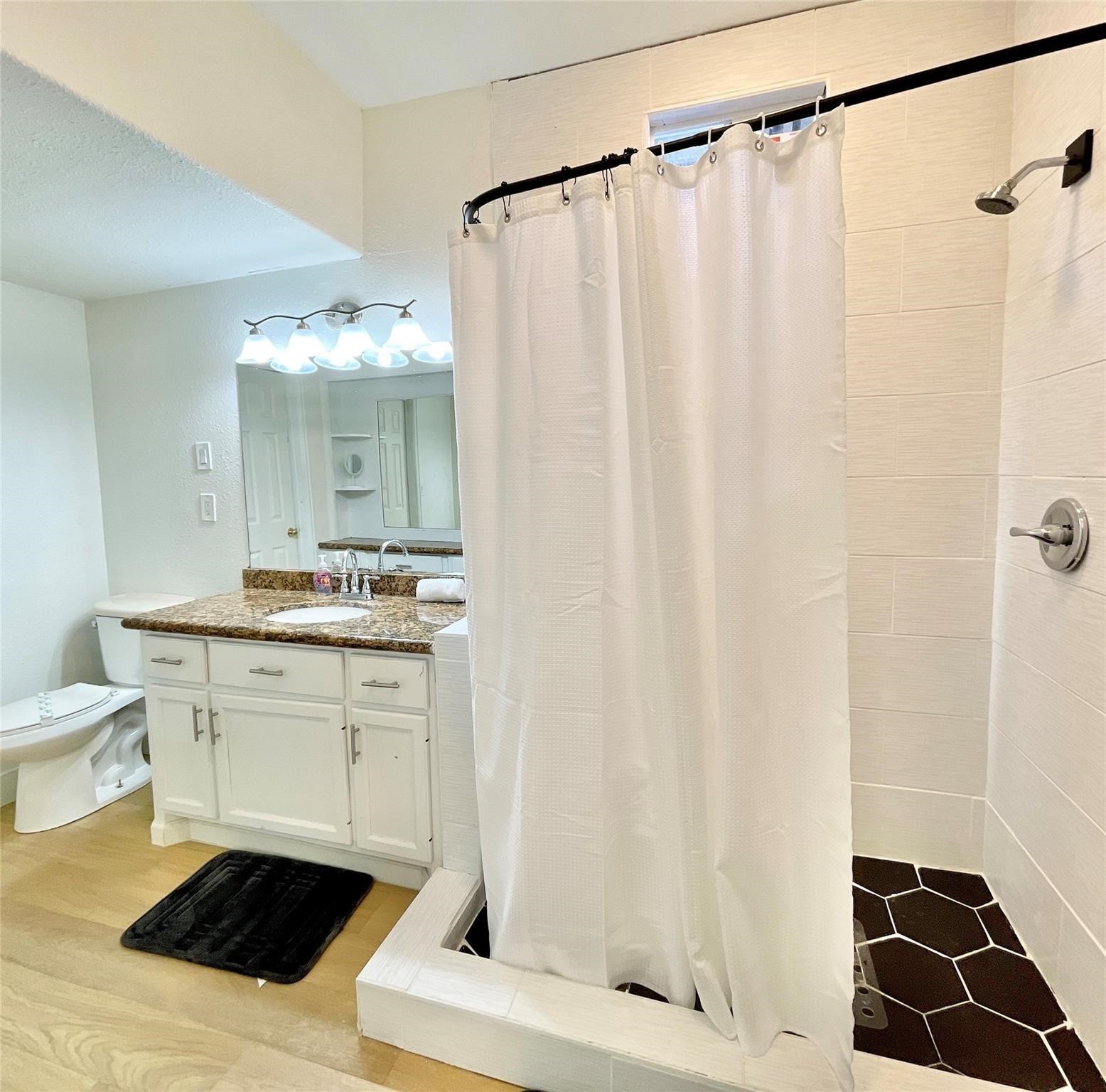 301 Tabor Street Houston, TX 77009 - Photo 12 of 14 a bathroom with a sink and a mirror