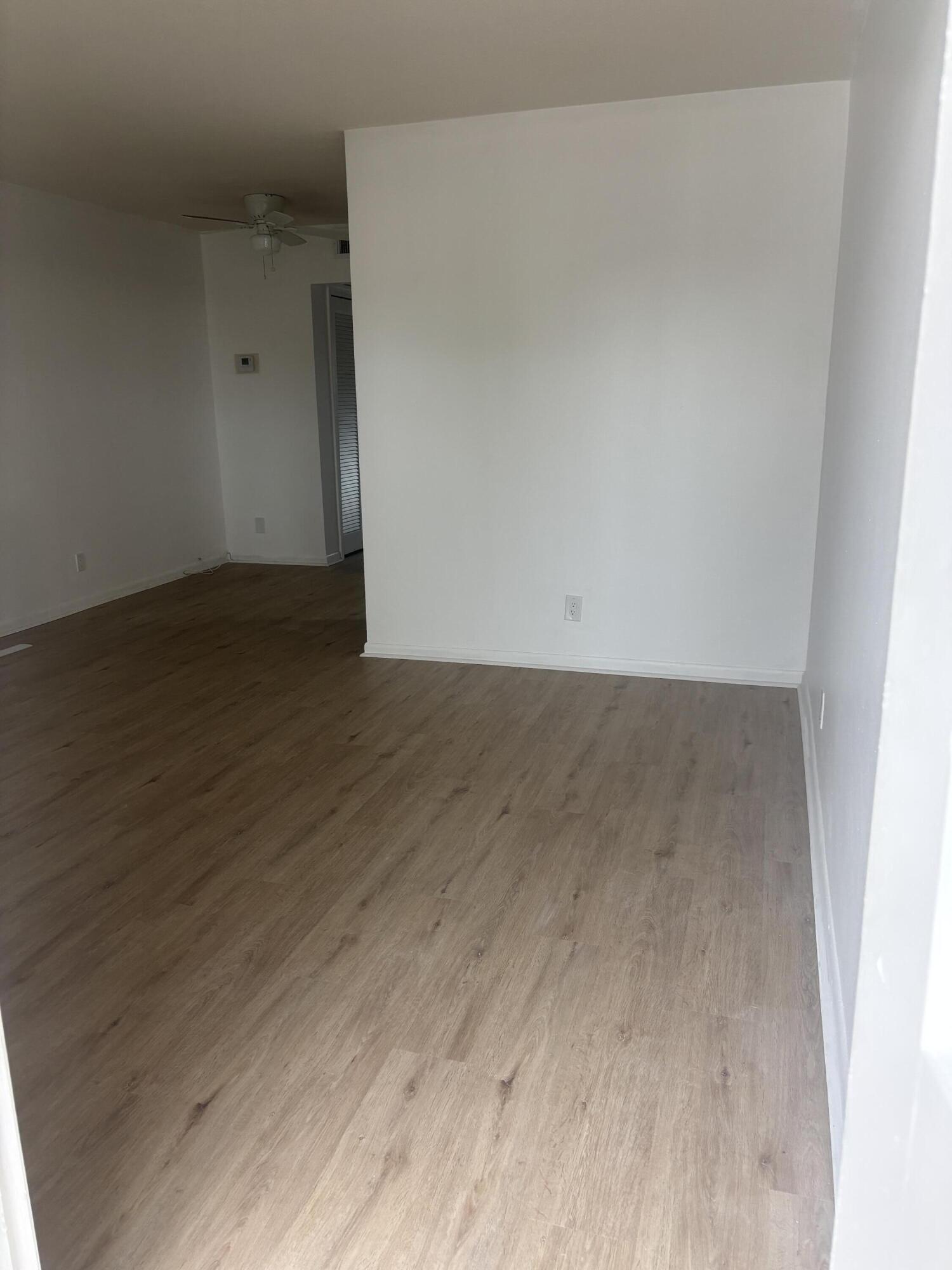 521 Northeast 45th Street Boca Raton, FL 33431 - Photo 2 of 17 a view of an empty room with wooden floor