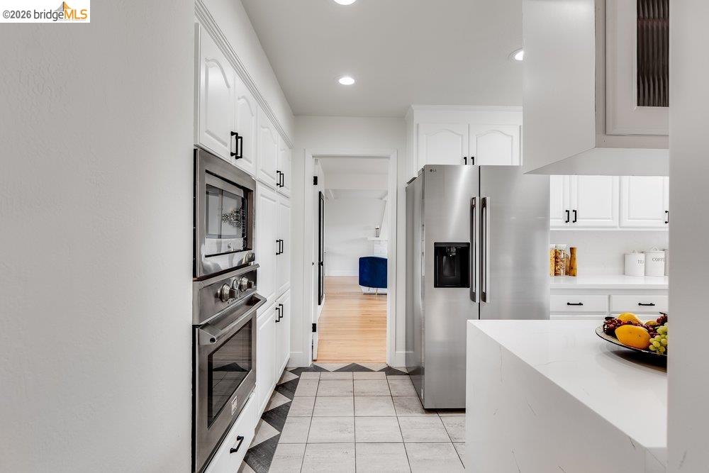 1298 Ribbon Street Foster City, CA 94404 - Photo 34 of 86 Kitchen featuring white cabinetry, stainless steel appliances, recessed lighting, and a patterned tile floor