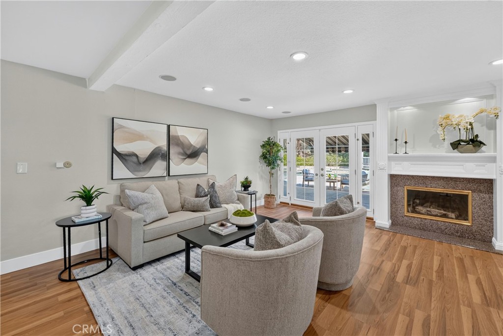 2935 Bluebell Avenue Brea, CA 92821 - Photo 13 of 38 Spacious family room featuring a cozy fireplace and seamless access to the backyard