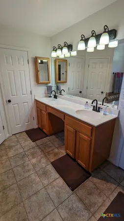 a spacious bathroom with a sink vanity and mirror