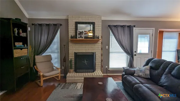 a living room with furniture a window and a fireplace