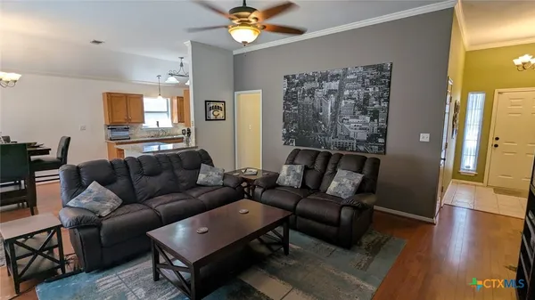a living room with furniture and a wooden floor