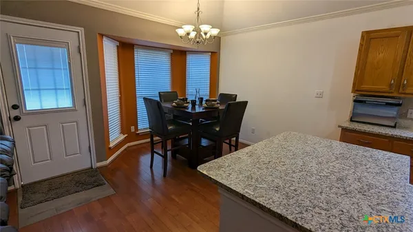 a view of a dining room with furniture and wooden floor