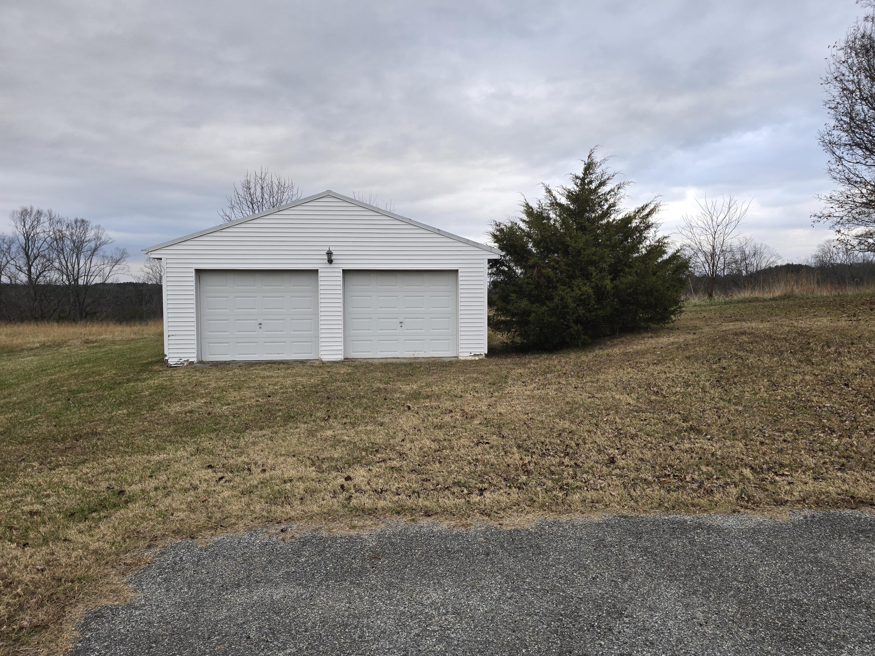 15917 A Moneta Road Moneta, VA 24121 - Photo 3 of 5 a white house that has a small yard and a large trees