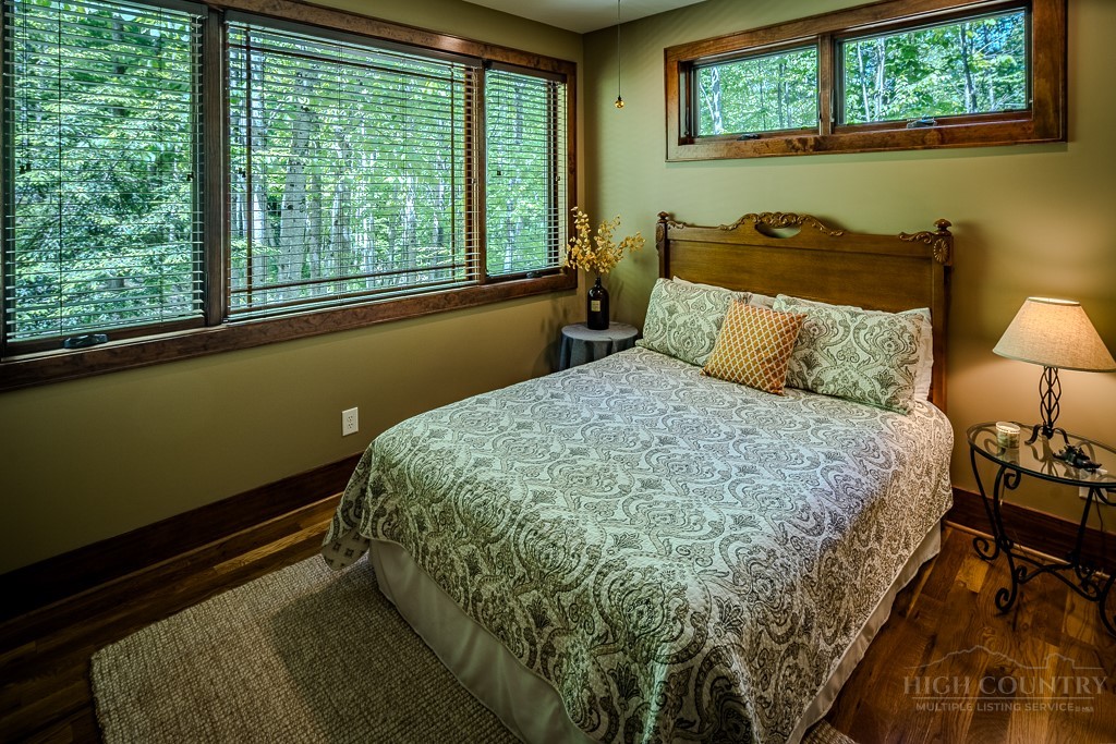 485 Woodlake Loop Road Elk Park, NC 28622 - Photo 20 of 44 a bed sitting in a bedroom next to a window