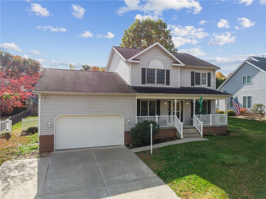 227 Sandworks Road Hunker, PA 15639 - Photo 2 of 41 a front view of a house with a yard and garage