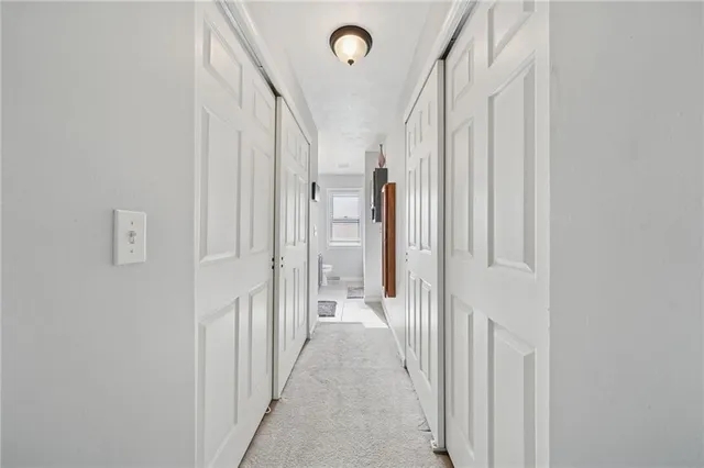 a bathroom with a granite countertop sink a toilet and mirror