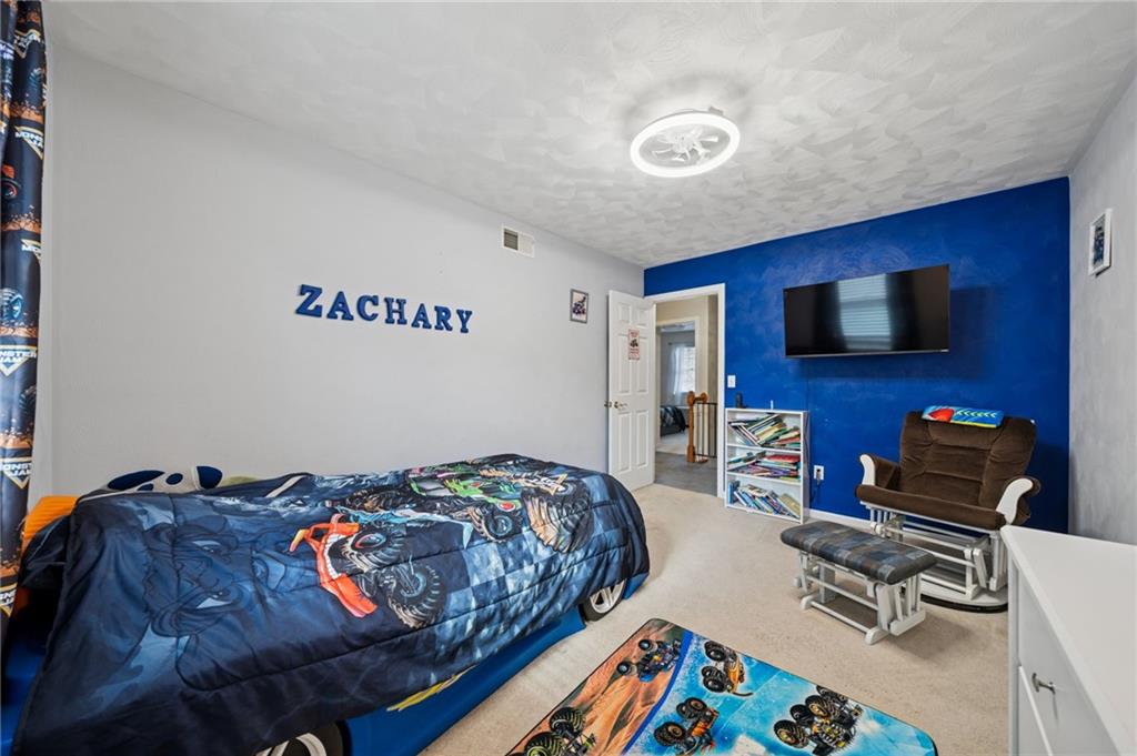 227 Sandworks Road Hunker, PA 15639 - Photo 23 of 41 a bedroom with a bed and a flat screen tv