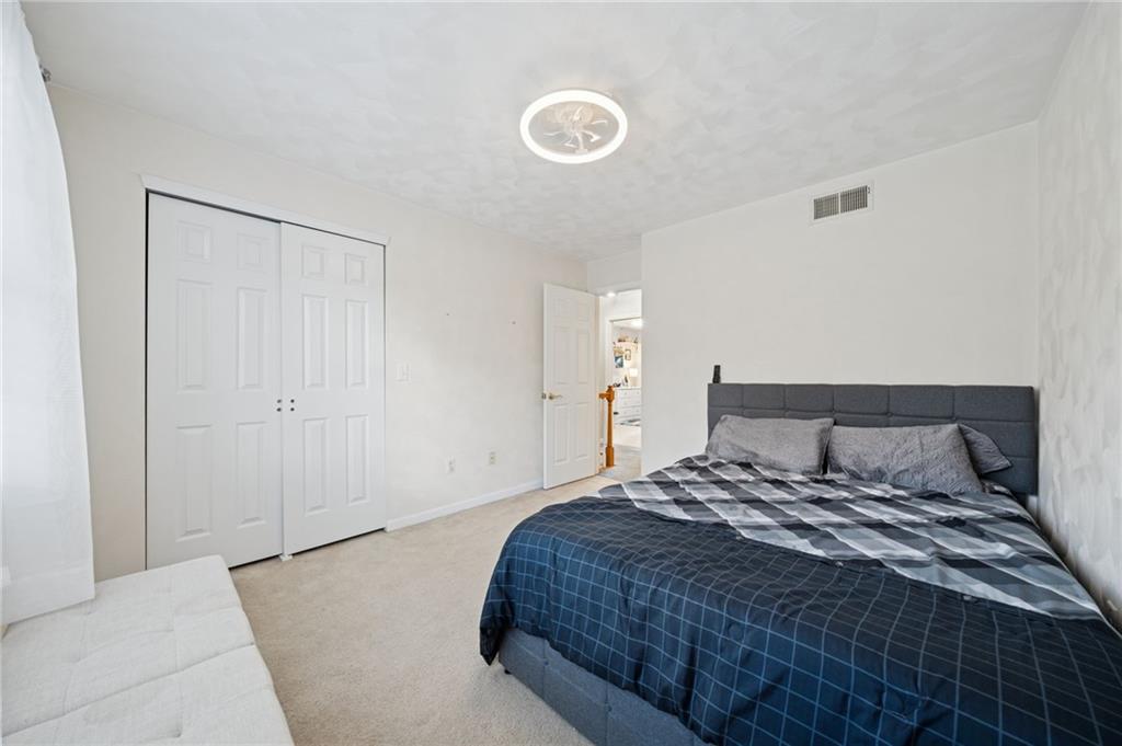 227 Sandworks Road Hunker, PA 15639 - Photo 28 of 41 a bedroom with a large bed and a chandelier