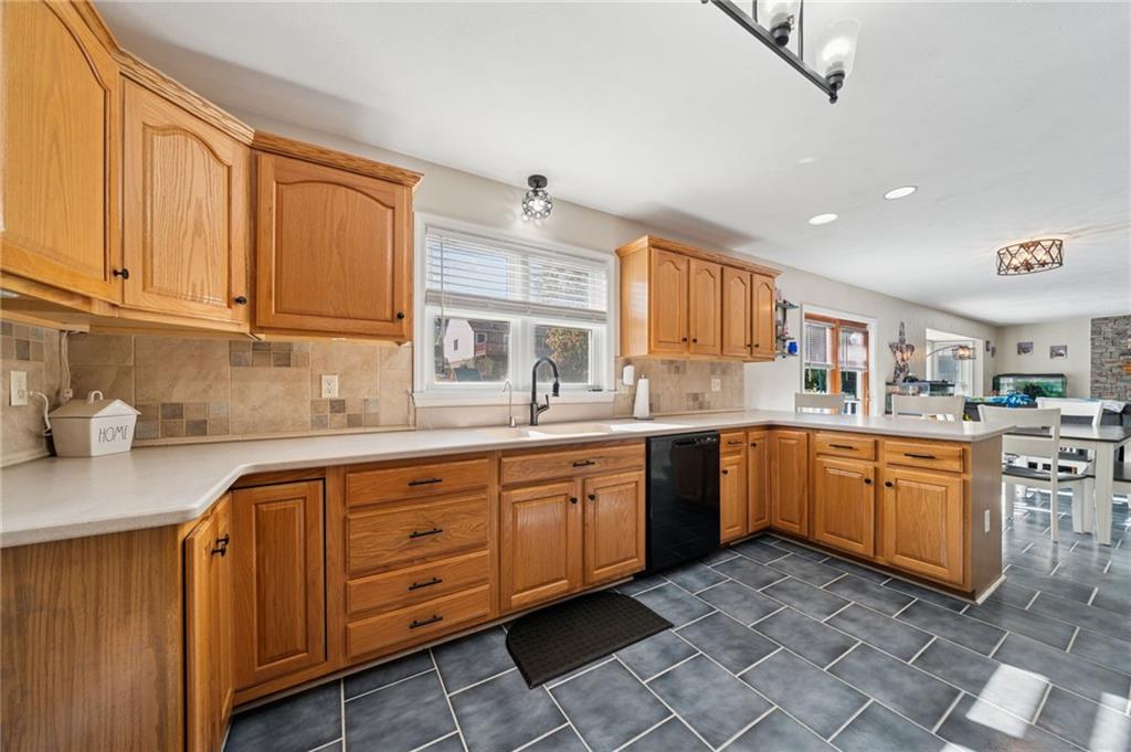 227 Sandworks Road Hunker, PA 15639 - Photo 6 of 41 a kitchen with granite countertop a sink cabinets and window