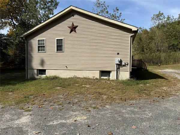 a view of house with backyard and trees