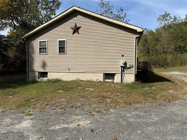 a view of house with backyard and trees