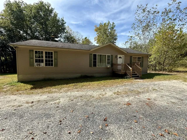 a house with trees in the background