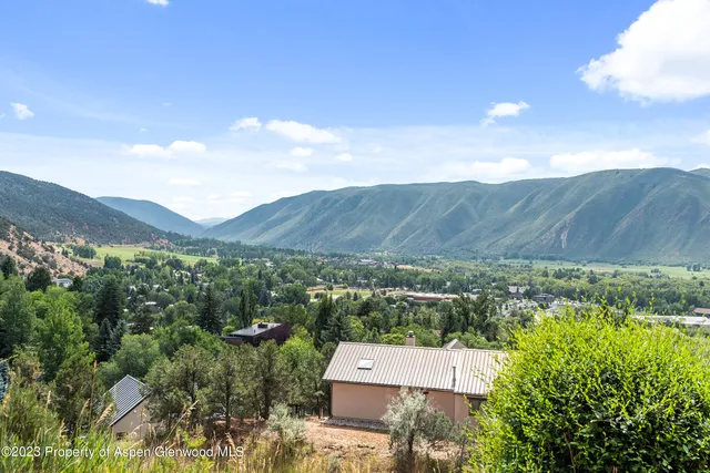an aerial view of a house with mountain view