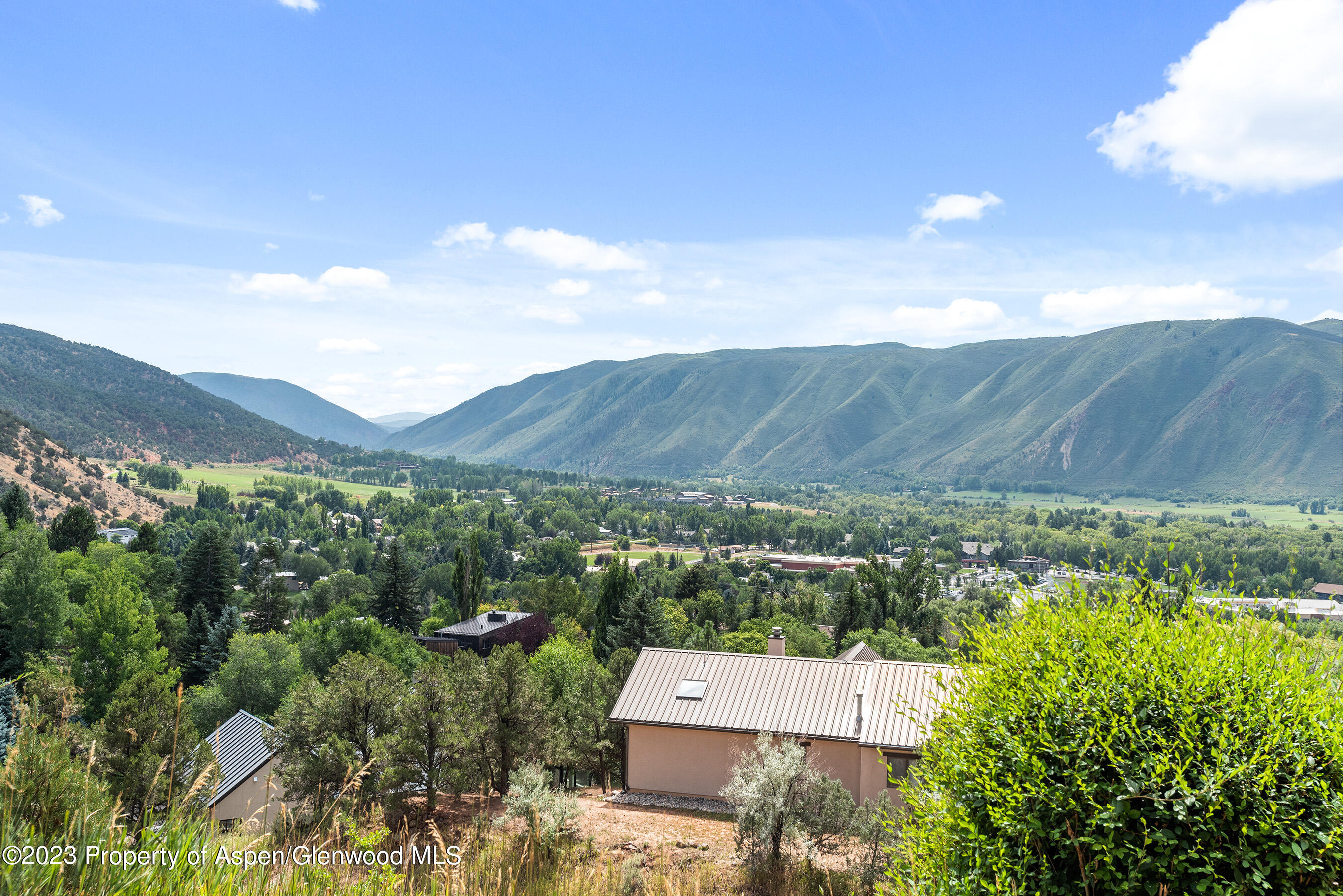 an aerial view of a house with mountain view