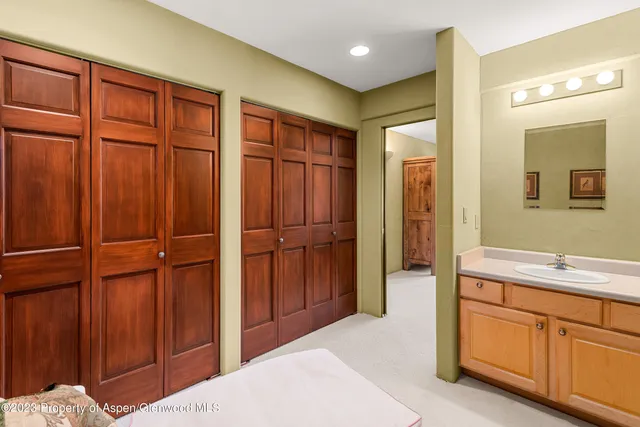 a spacious bathroom with a sink and a mirror