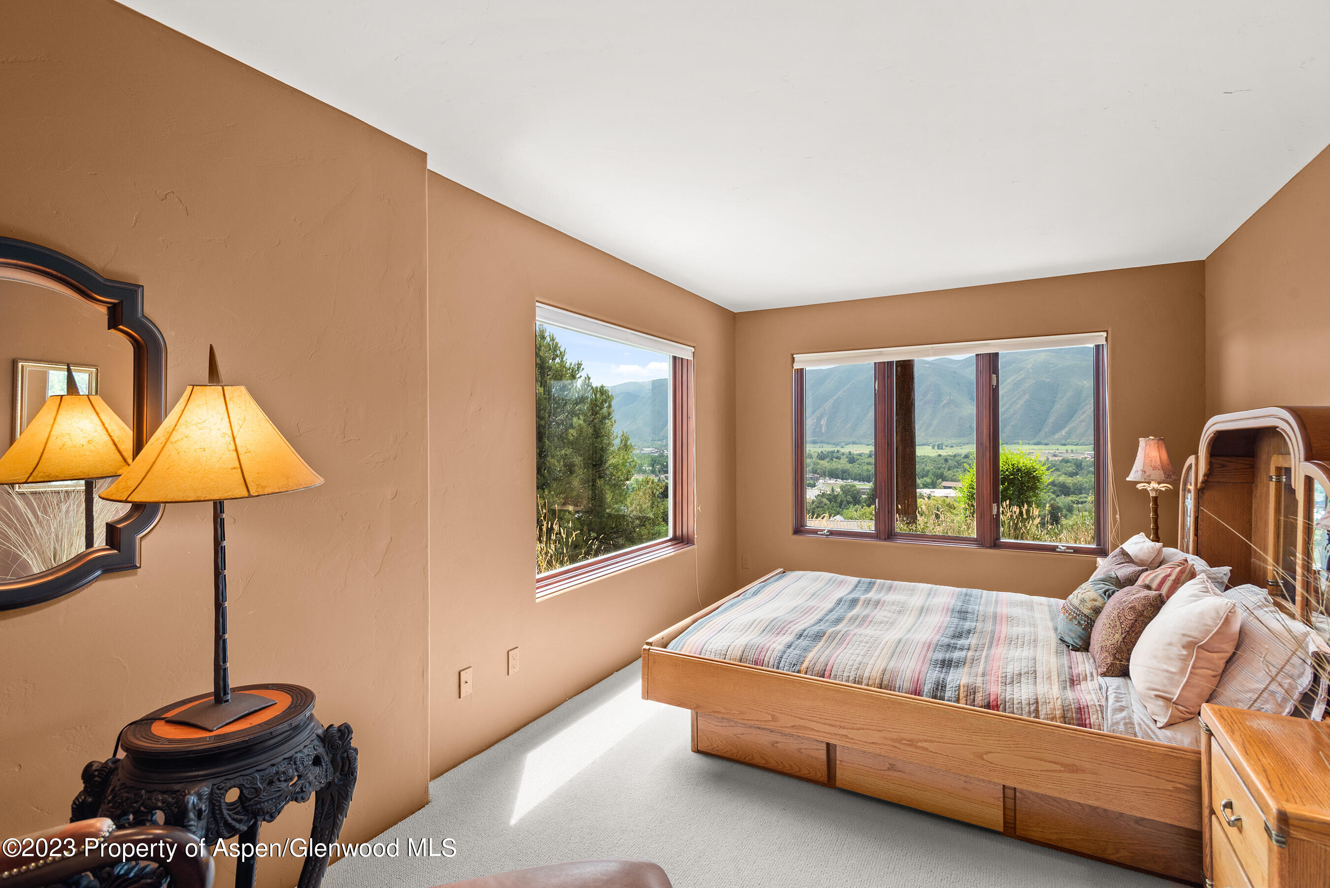 132 Ridge Road Basalt, CO 81621 - Photo 13 of 22 a bedroom with a bed and lamp next to a window