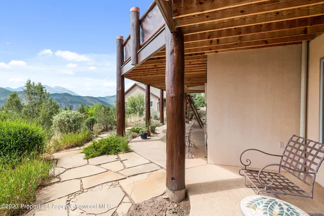 a view of a balcony with chair and table in the patio