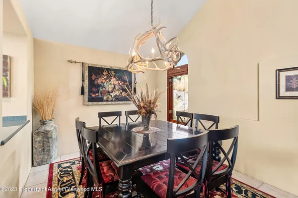 a view of a dining room with furniture and chandelier