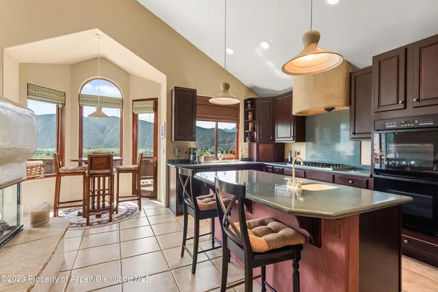 a kitchen with a table chairs and microwave