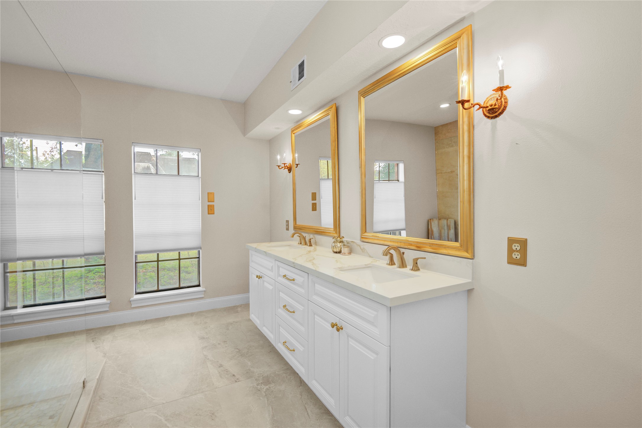 8412 Hidden Trail Lane Spring, TX 77379 - Photo 18 of 43 The beautifully upgraded primary bathroom showcases a long dual-sink vanity, elegant mirrors, and abundant lighting for a bright, refined space.