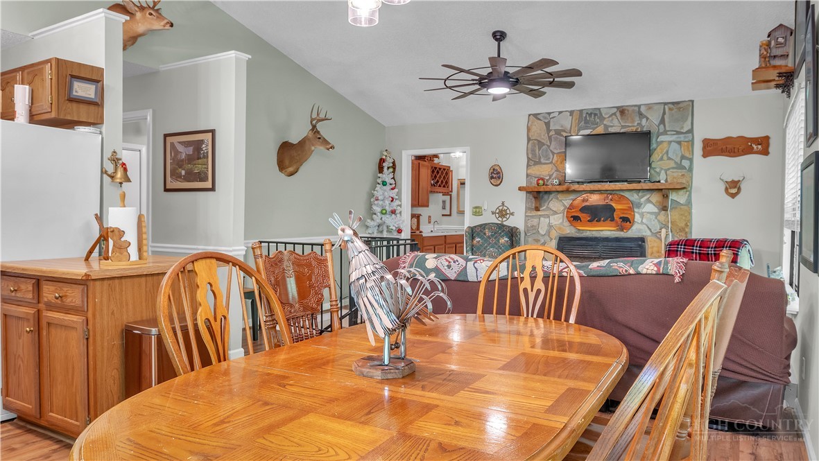 117 Rhododendron Drive Beech Mountain, NC 28604 - Photo 10 of 33 a dining room with stainless steel appliances furniture a chandelier and a flat screen tv