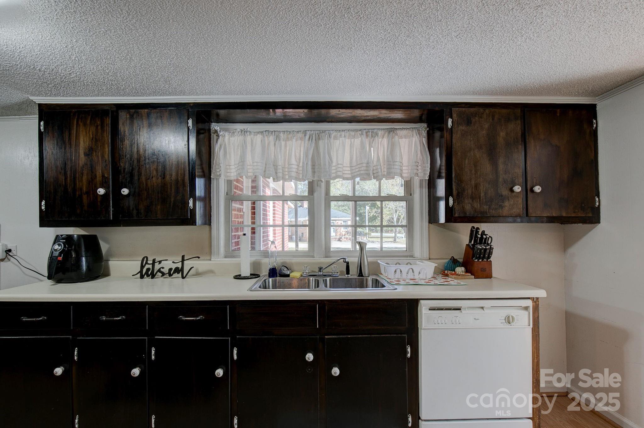 951 Evans Mill Road Pageland, SC 29728 - Photo 11 of 28 a kitchen with a sink cabinets and window
