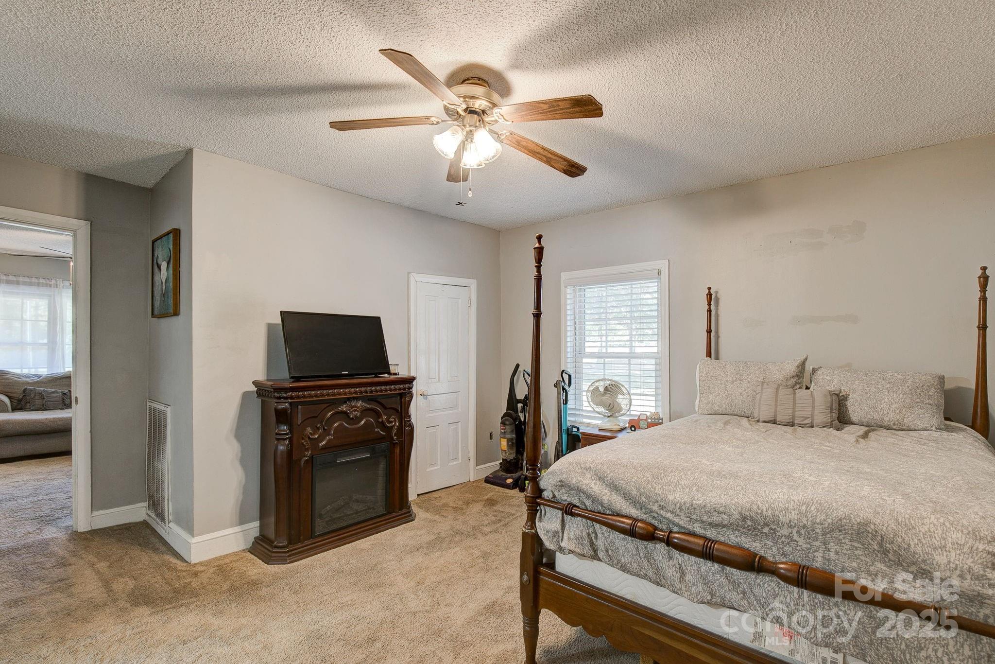 951 Evans Mill Road Pageland, SC 29728 - Photo 15 of 28 a bedroom with a bed and a tv