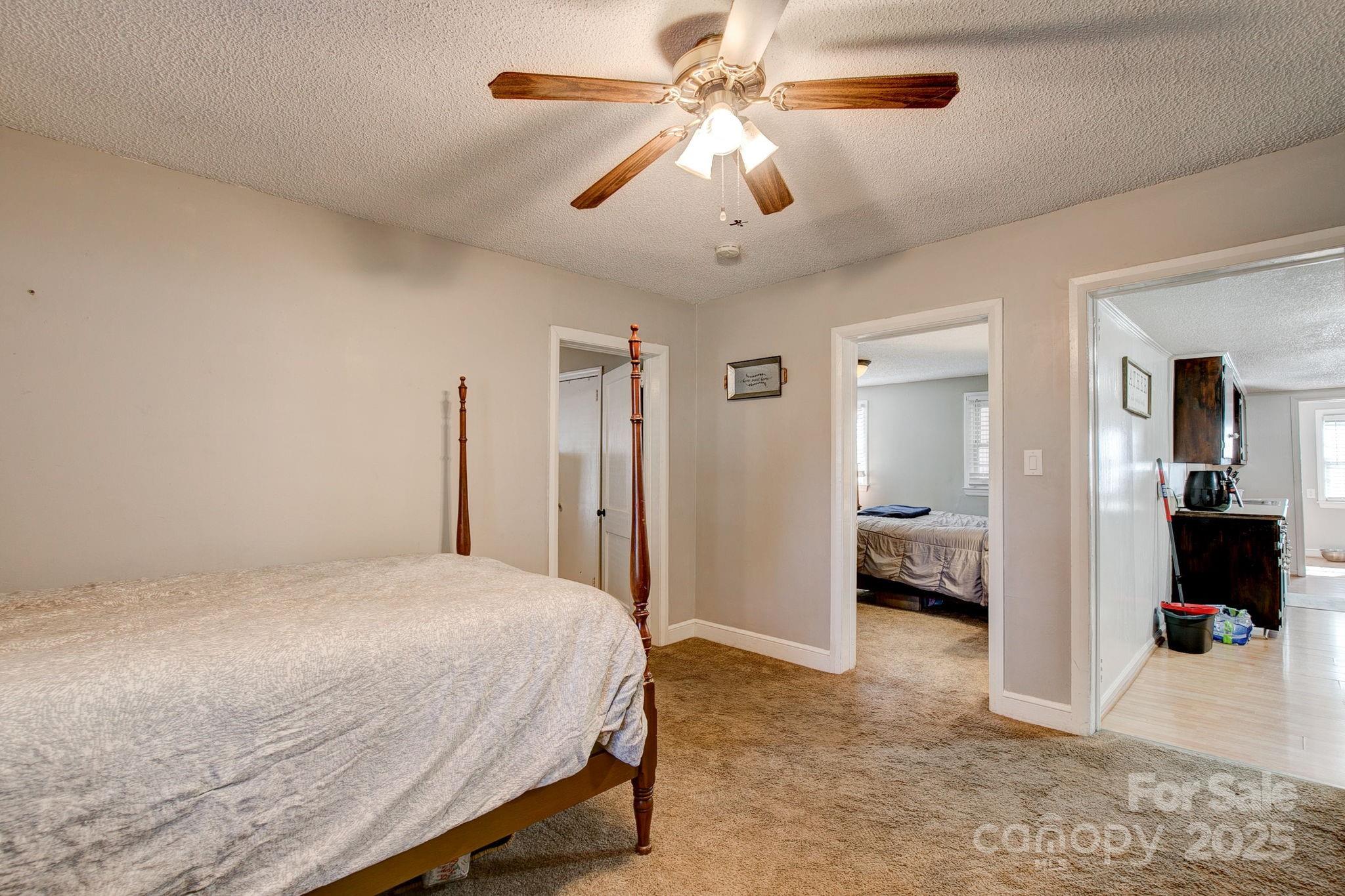 951 Evans Mill Road Pageland, SC 29728 - Photo 16 of 28 a bedroom with a bed and a chandelier