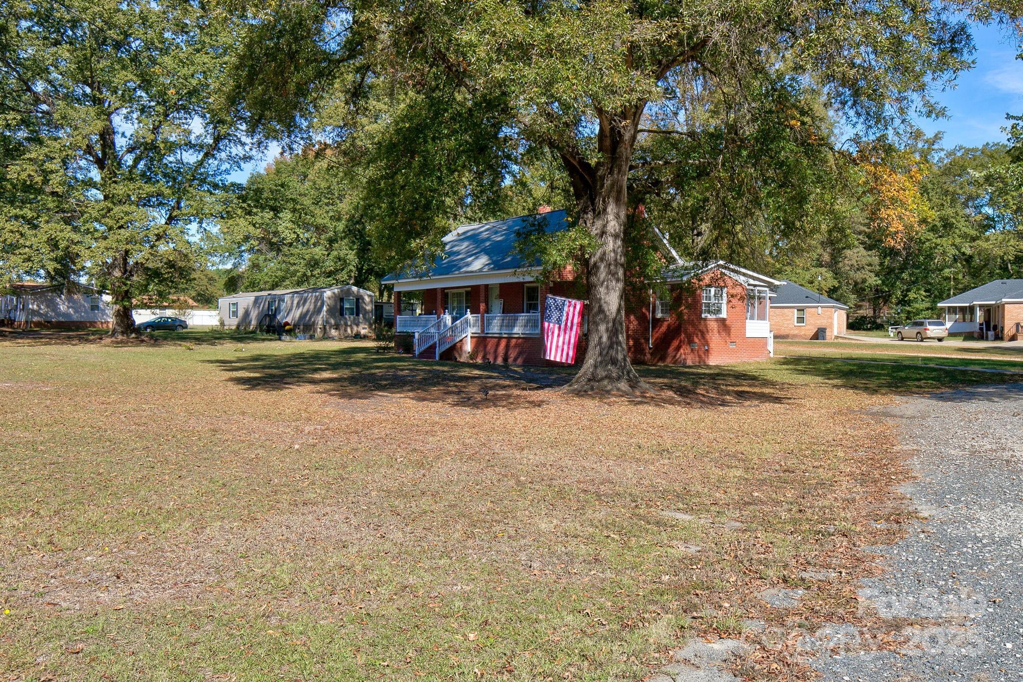 951 Evans Mill Road Pageland, SC 29728 - Photo 24 of 28 a view of swimming pool with outdoor seating and covered with trees