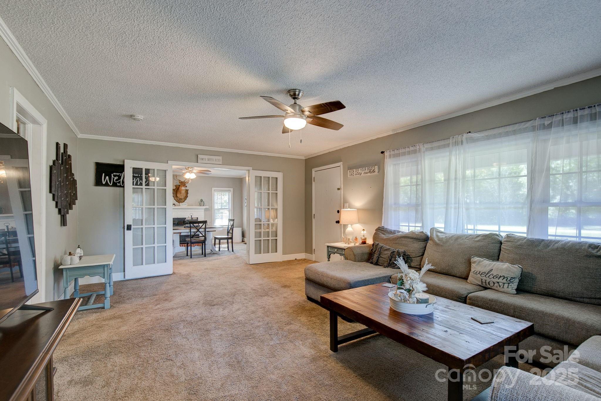 951 Evans Mill Road Pageland, SC 29728 - Photo 6 of 28 a living room with furniture a table and a large window