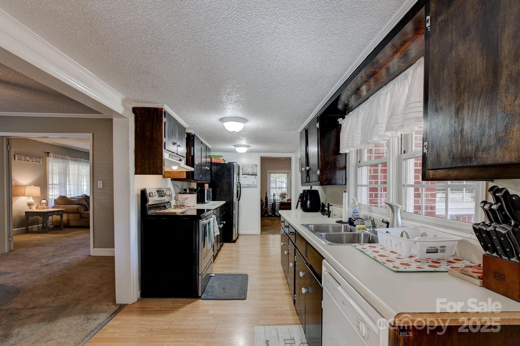 951 Evans Mill Road Pageland, SC 29728 - Photo 9 of 28 a kitchen with stainless steel appliances kitchen island granite countertop a sink stove and refrigerator