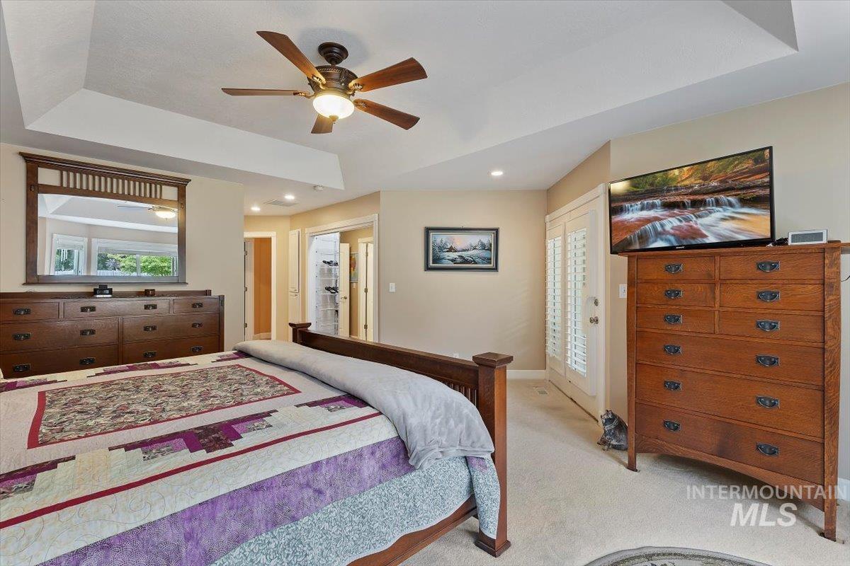 5184 North Greyloch Way Boise, ID 83704 - Photo 11 of 32 Carpeted bedroom featuring a tray ceiling with a ceiling fan, recessed lighting, and light beige wall tones