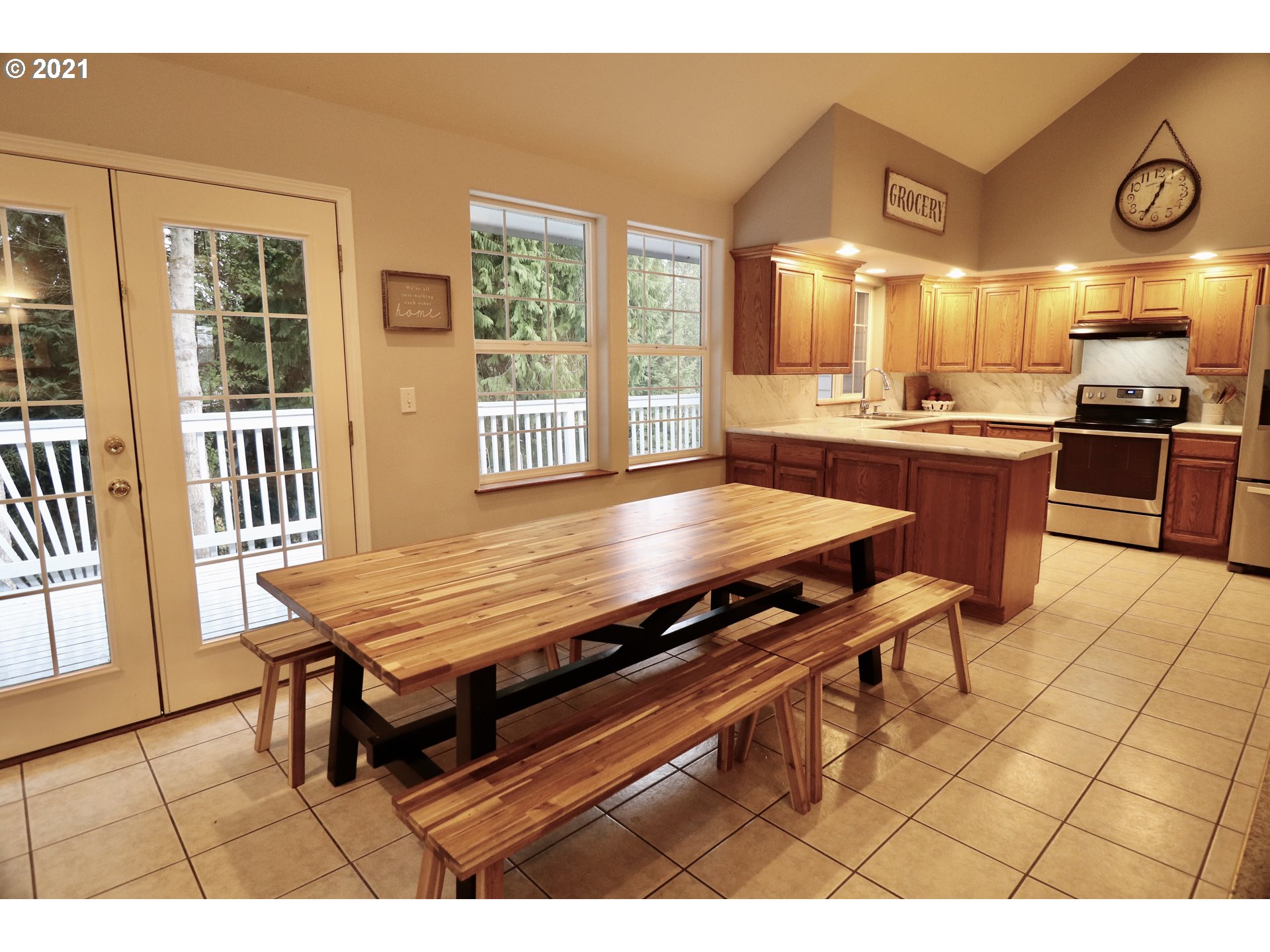 204 Wohl Road Longview, WA 98632 - Photo 8 of 31 a dining hall with stainless steel appliances kitchen island granite countertop a table chairs and a large window