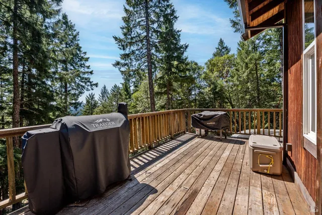 a view of deck with table and chairs and wooden floor