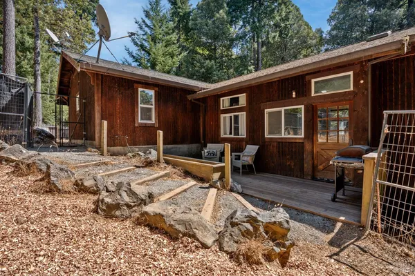 a view of a house with backyard and sitting area