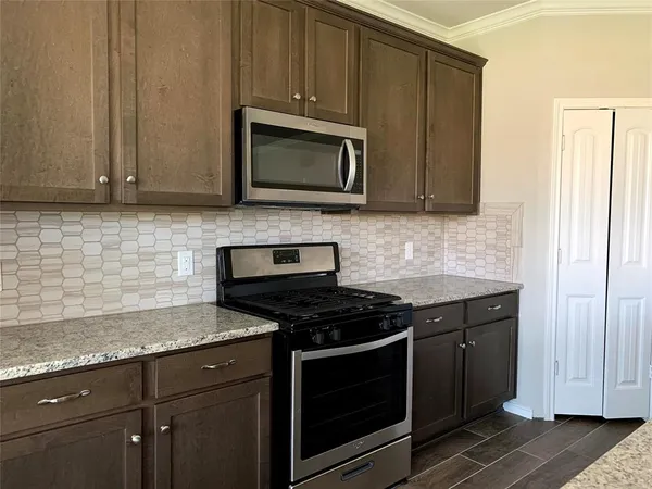 a kitchen with appliances cabinets and a counter top space